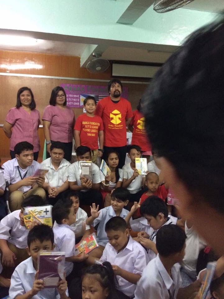 Abaka teachers with Filipino students during a classroom book outreach